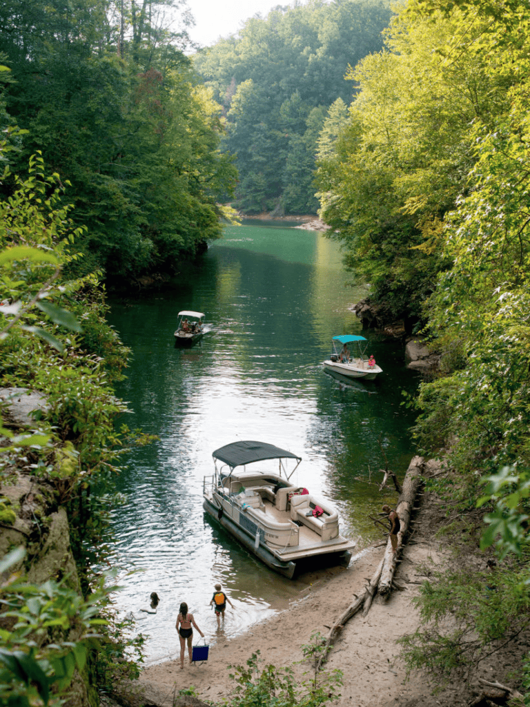- Tranquil river with boats and lush green trees at a scenic outdoor waterside.