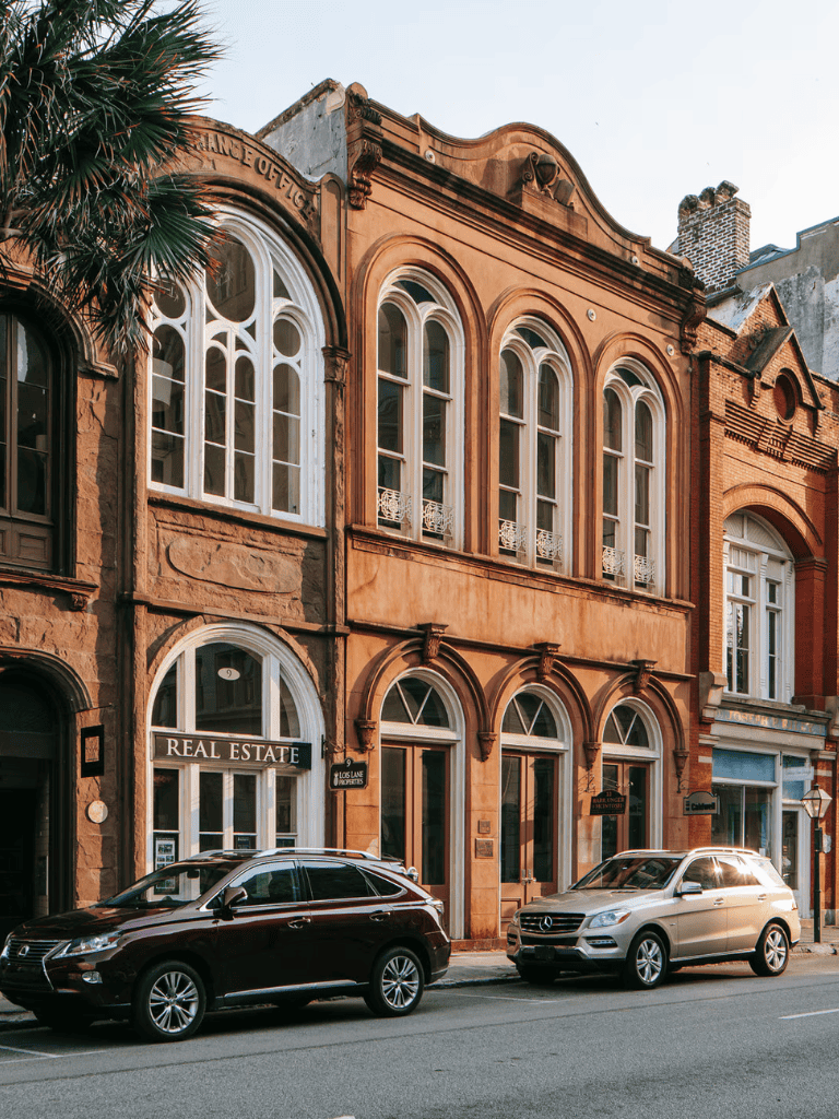 Charming historic building with real estate office and classic architecture on a city street.