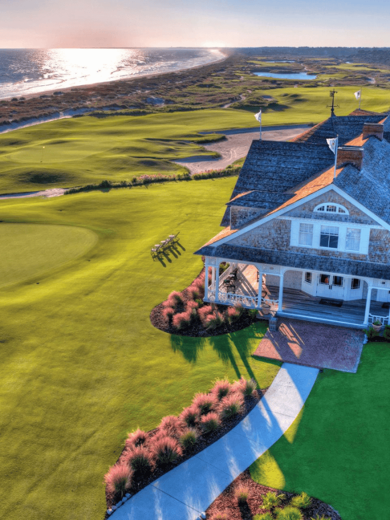 Sweeping coastal golf course with ocean view and elegant clubhouse, perfect for golf enthusiasts.