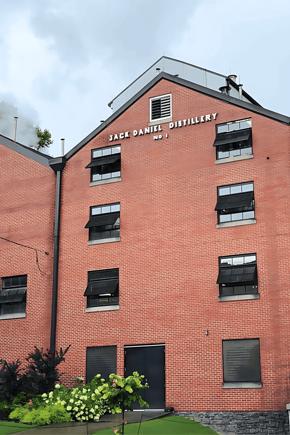 Historic Jack Daniel Distillery building in Lynchburg, TN, showcasing whiskey craftsmanship and scenic surroundings.