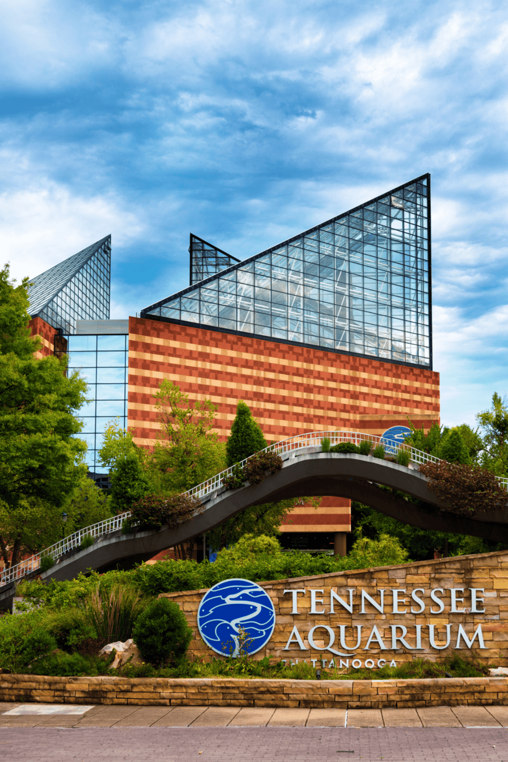 Modern Tennessee Aquarium building in Chattanooga with glass architecture and lush landscaping.