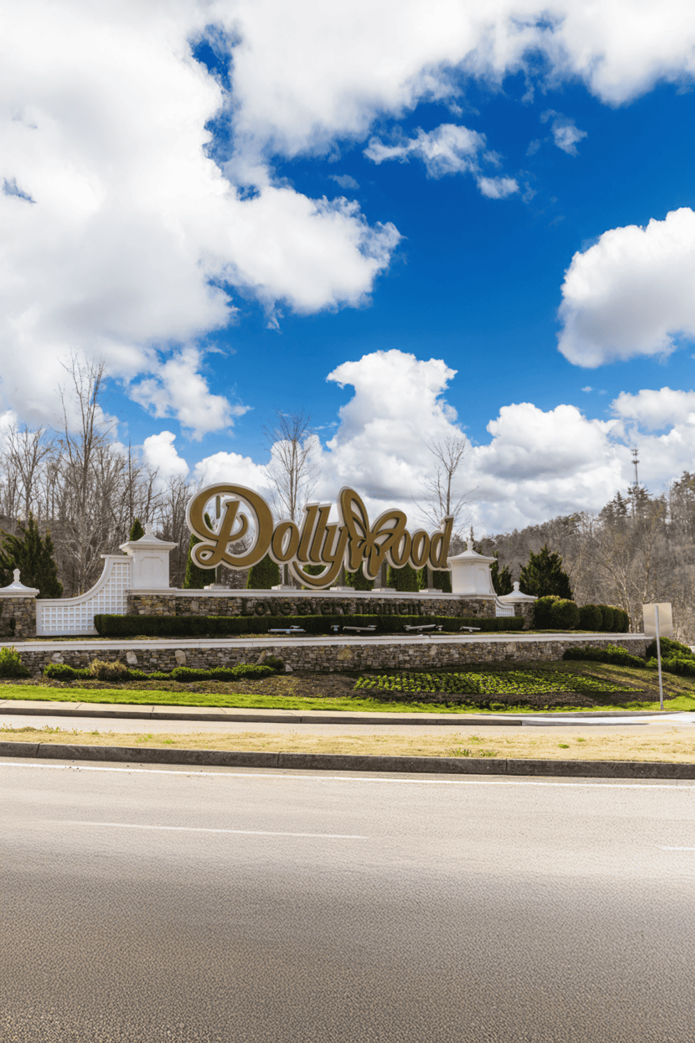 Dolly Parton-themed attraction entrance with scenic landscaping and sky view, located in Pigeon Forge, Tennessee.