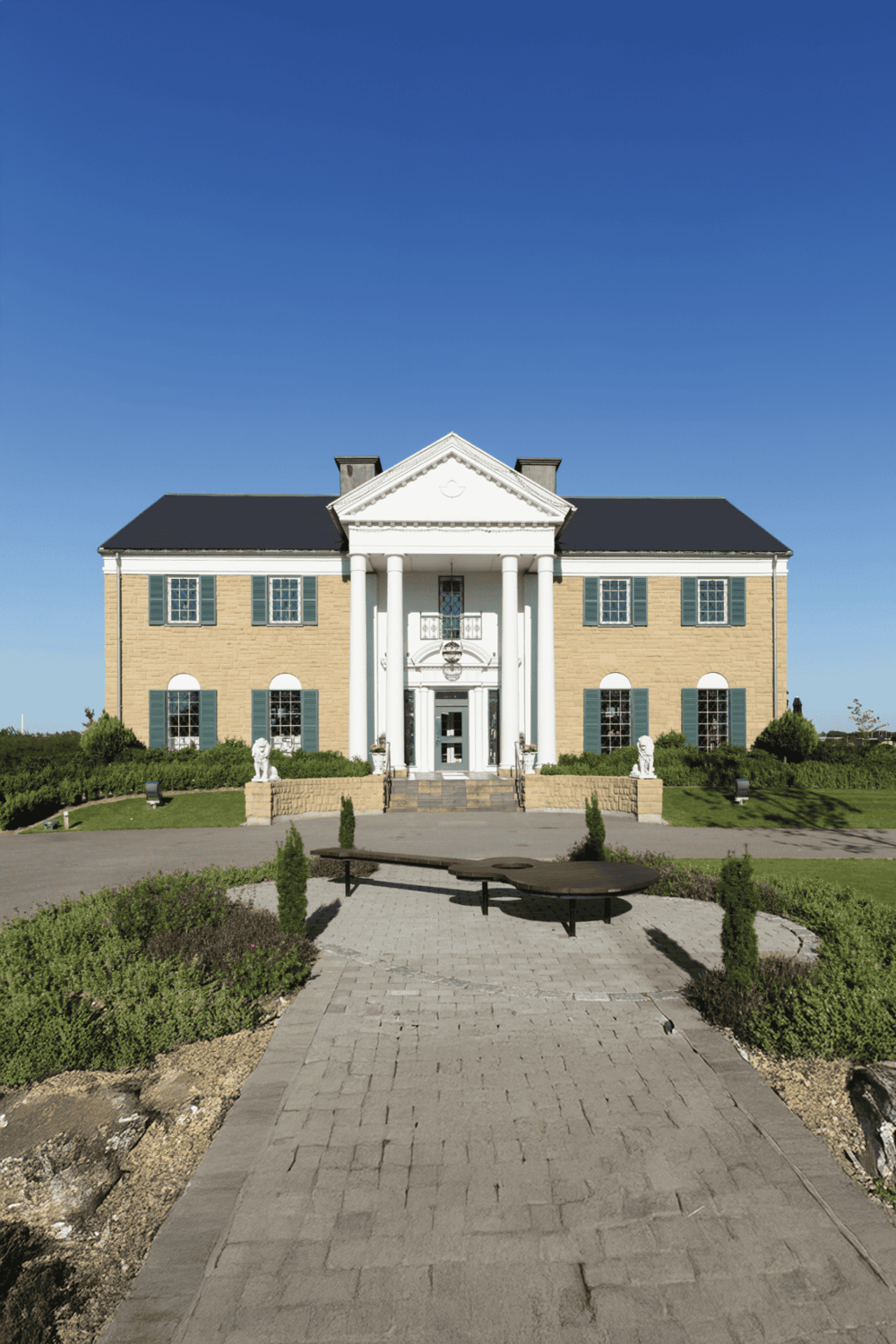 Elegant historic mansion with classic architecture and lush landscaping.