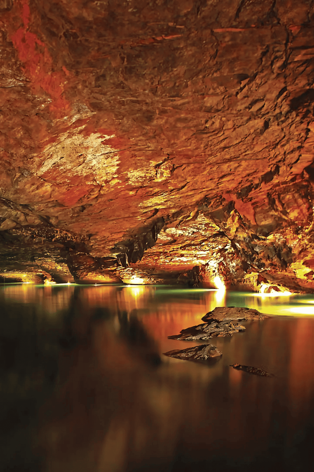 Hidden Canyon Underground Water Cave illuminated with colorful lighting.