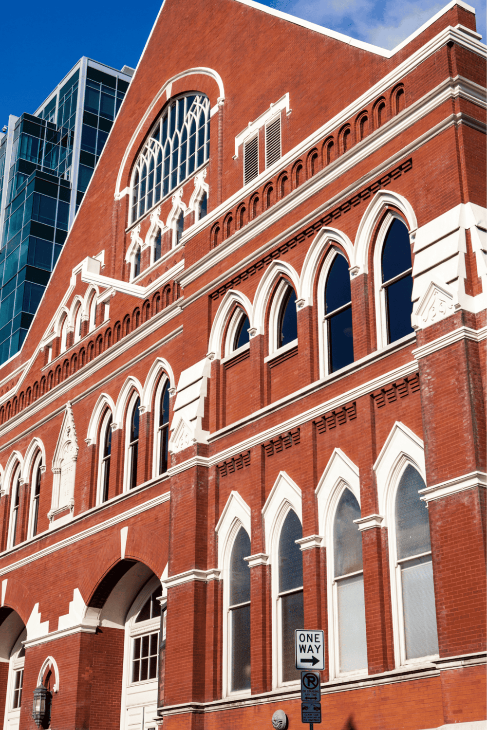 Historic red brick building with Gothic windows promoting QuestForDirections services.