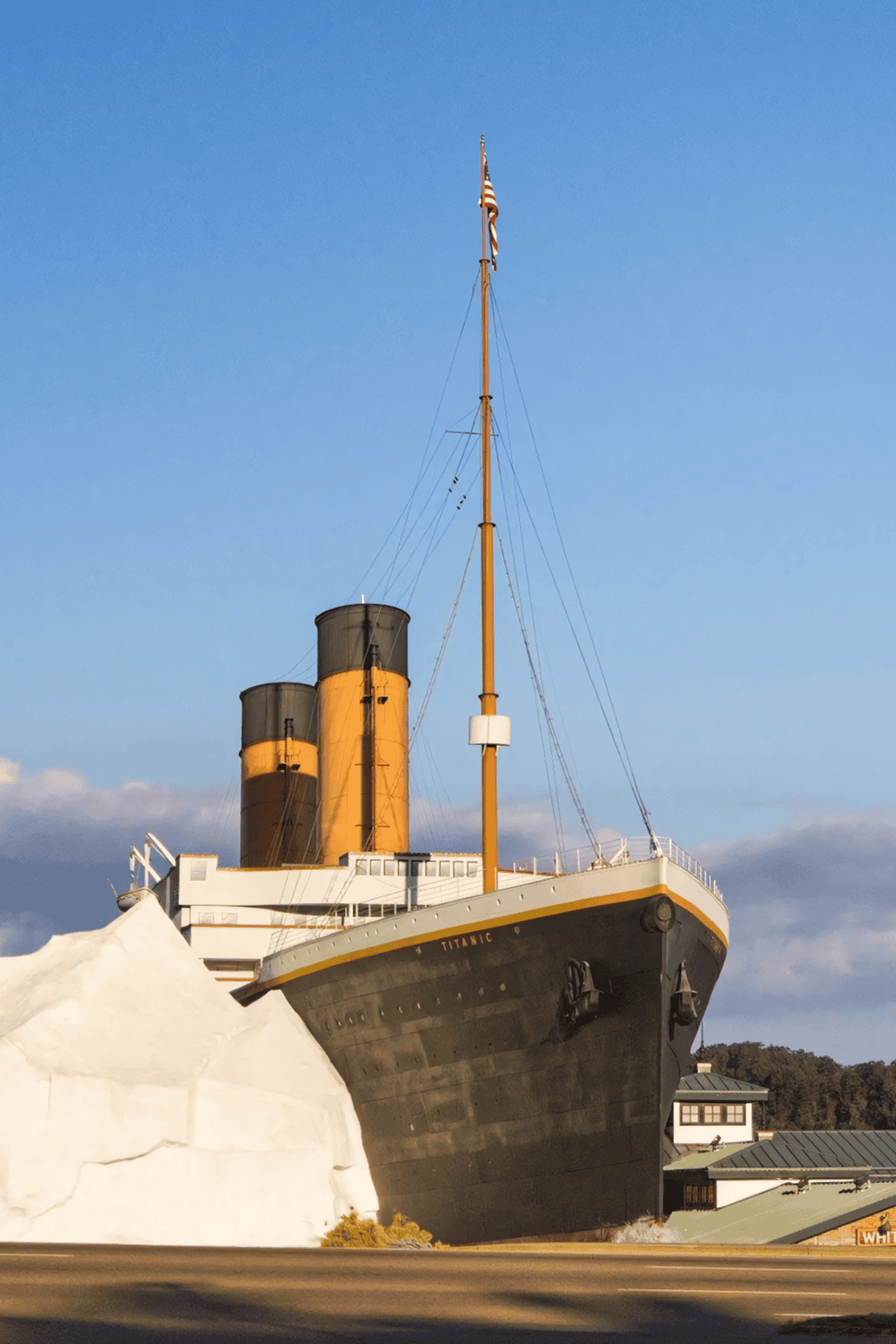 Tilted Titanic ship replica with icy iceberg at the museum, iconic attraction showcasing maritime history and engineering.