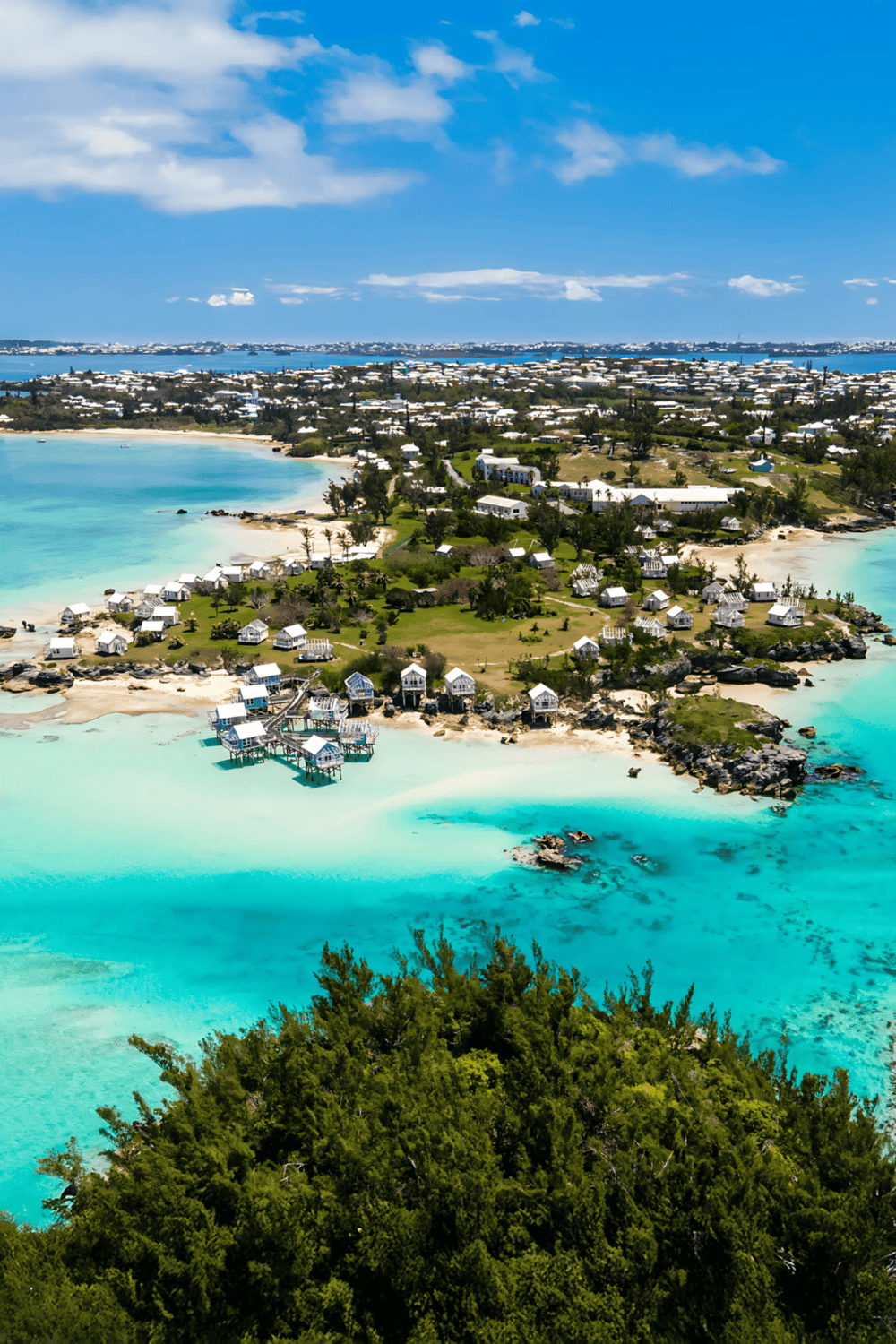 Colorful coastal island featuring overwater cottages and turquoise waters, perfect for travel planning and directions.