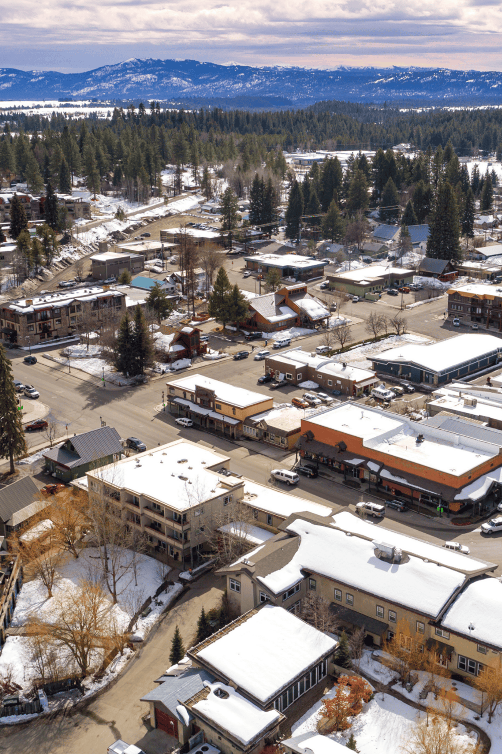 Snowy mountain townscape with streets, buildings, and trees in winter, showcasing scenic travel destinations with QuestForDirections.