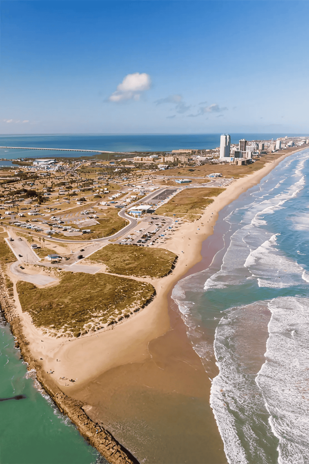 Aerial view of Gulfport Beach with shoreline, cityscape, and ocean waves, showcasing Gulfport Mississippi coastal attractions and scenic beauty.