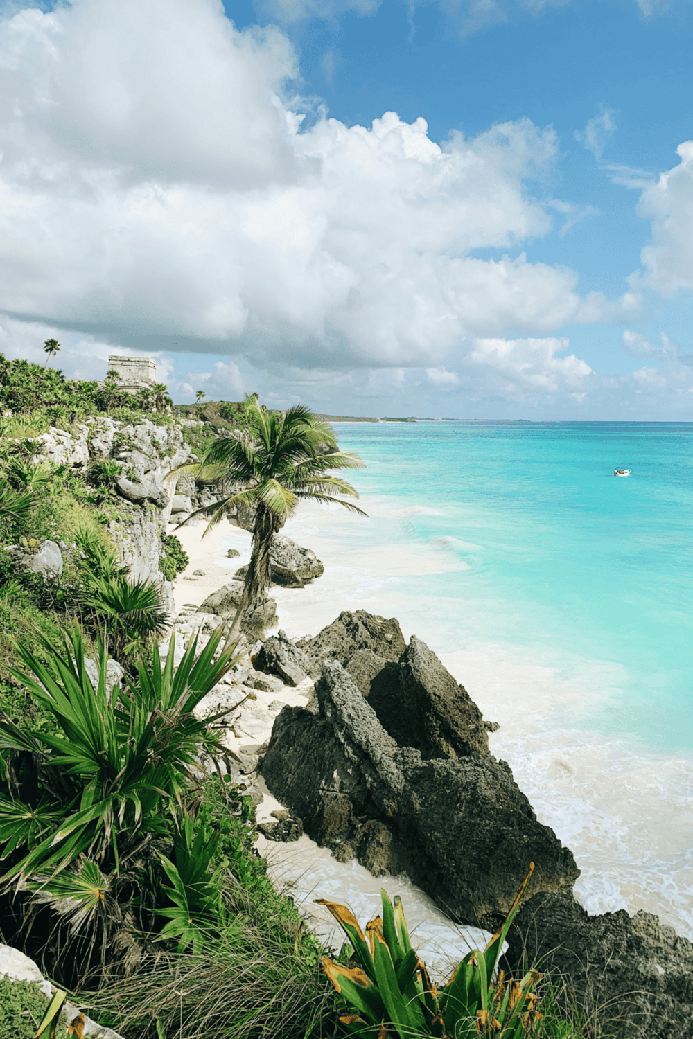 Breathtaking Caribbean beach with turquoise waters, lush greenery, and ancient ruins, perfect for travel planning.
