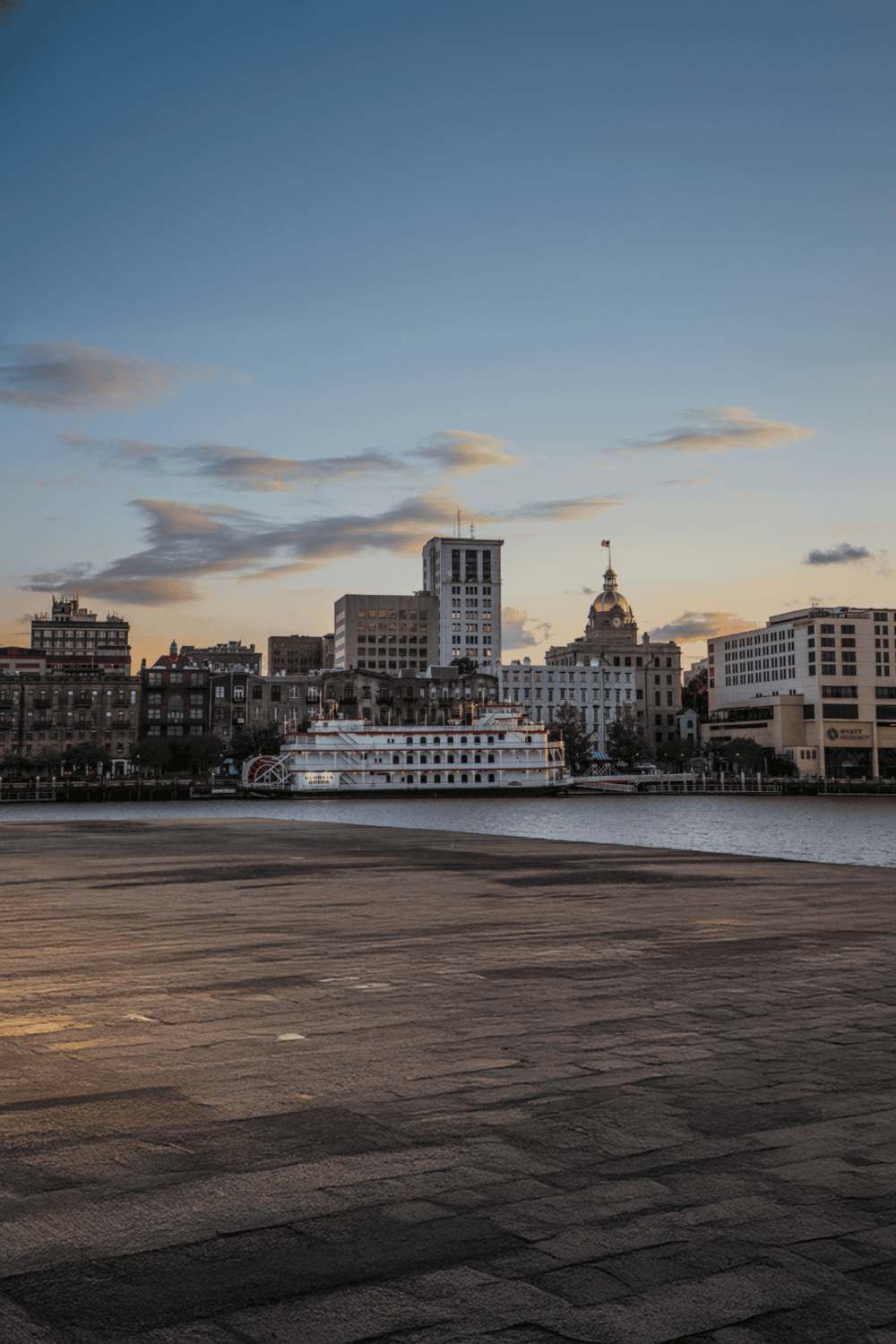 1. Downtown city skyline with river and boat at sunset, urban navigation, city exploration, travel navigation.