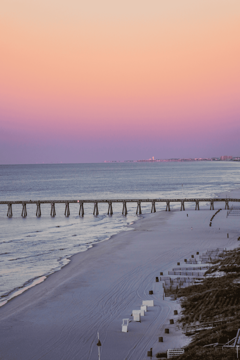 Serene beach with pier at sunset, perfect for travel and vacation planning | QuestForDirections SEO imagery.