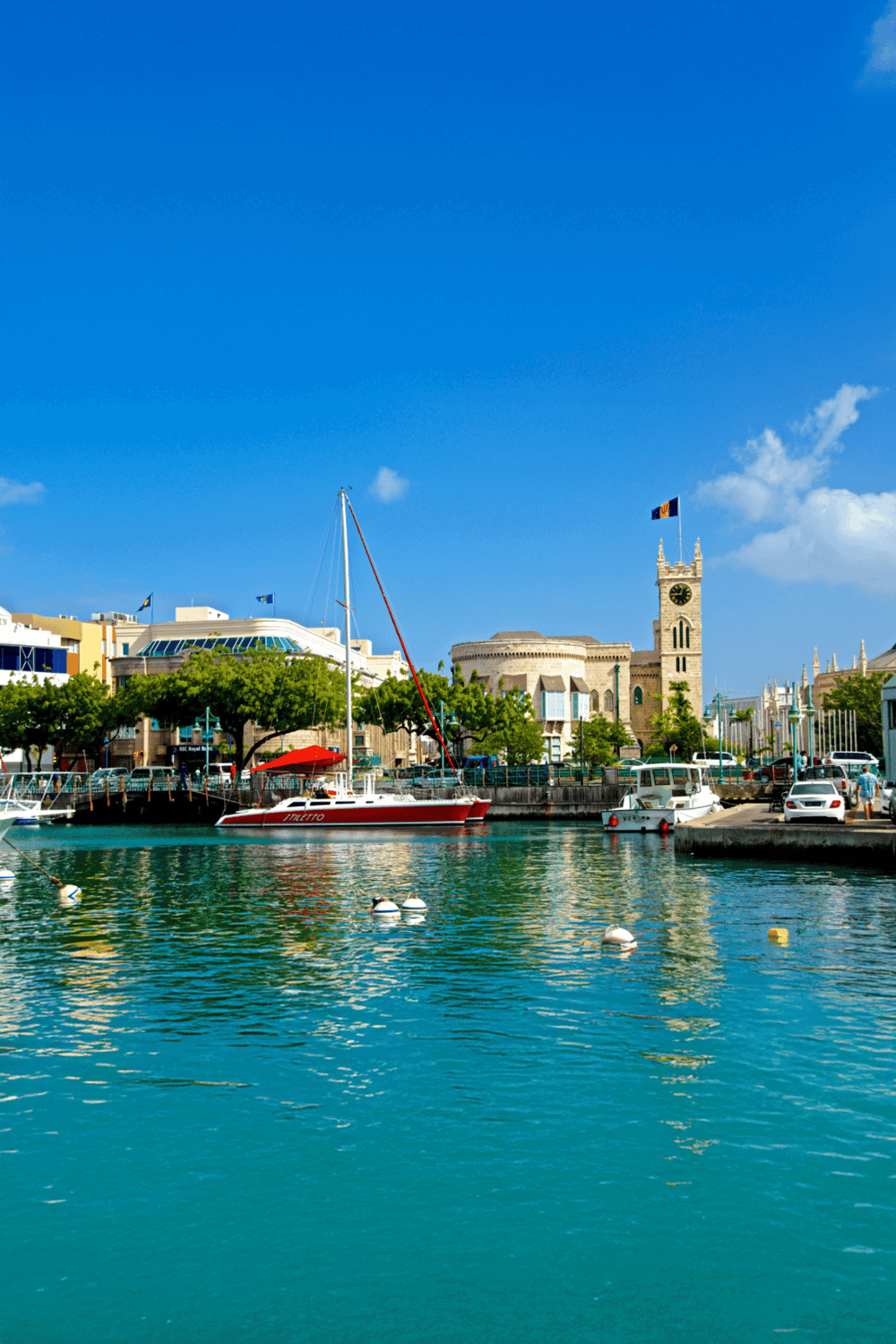 1. Scenic harbor with sailboats, historic buildings, and waterfront in Malta under a clear blue sky.