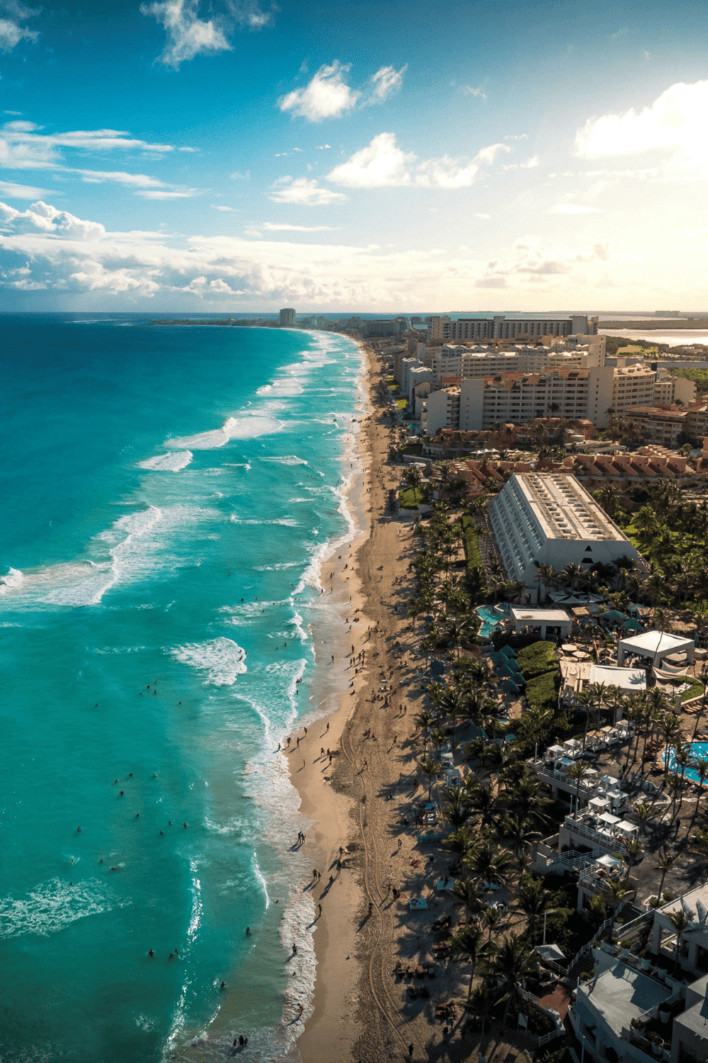 Vacation beach in Cancun with turquoise water and resort hotels, perfect for travel planning and seaside getaways.