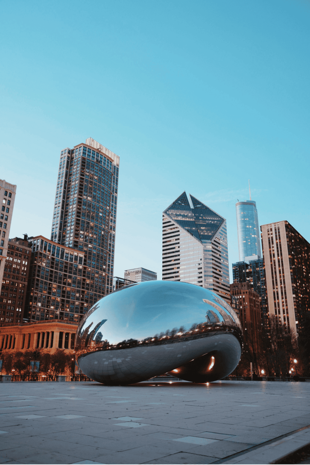 Sculpture in downtown Chicago with skyscrapers in the background, modern cityscape, iconic urban art, city attractions.