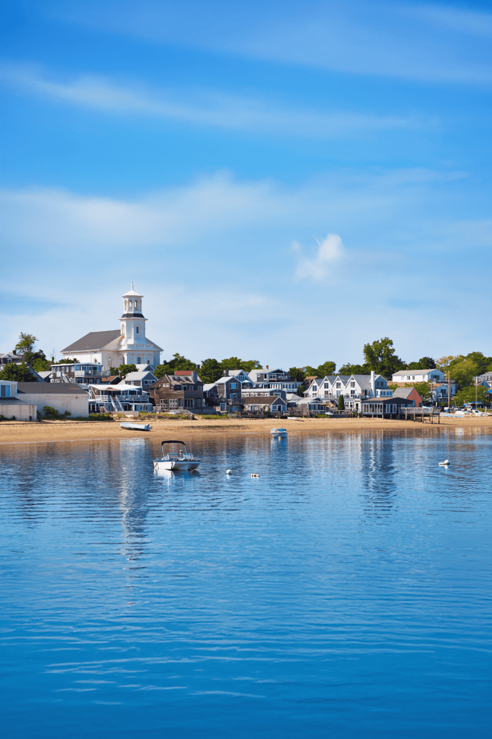 Charming waterfront town with scenic views and boats in the harbor. Perfect destination for travel and adventure.