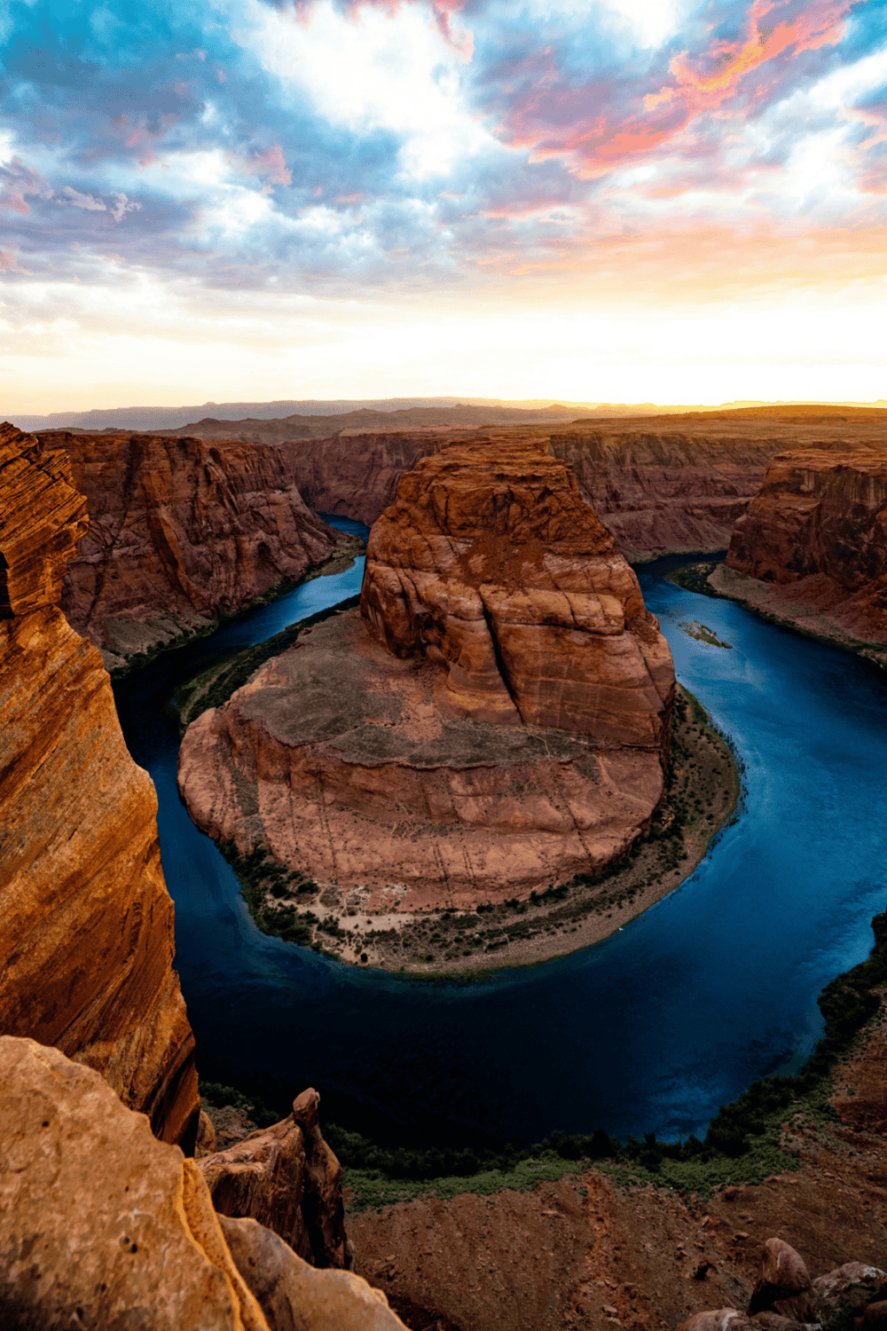 Majestic Horseshoe Bend at sunset, showcasing stunning Colorado River views and vivid rock formations.