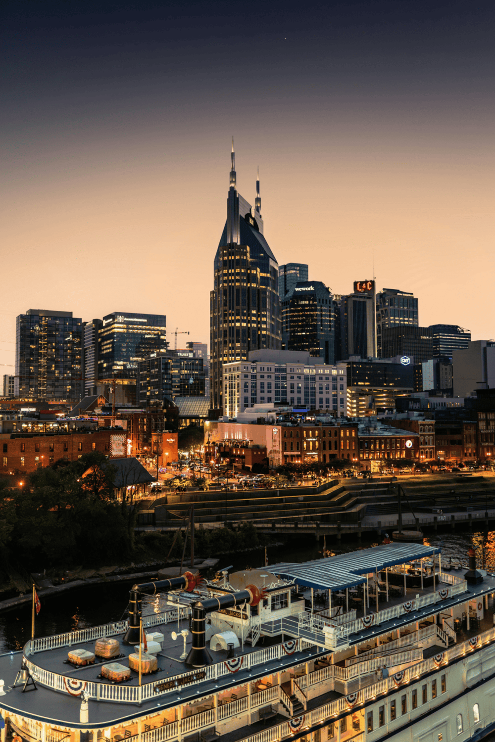 Brewing up the skyline, the historic riverboat in Nashville with downtown skyscrapers at sunset.