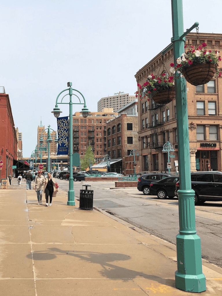 Colorful city street scene with historic brick buildings and street lamps, welcoming atmosphere, perfect for exploring downtown attractions.