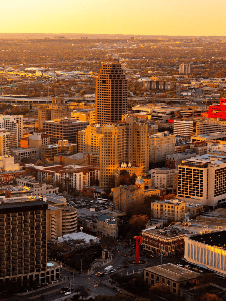 Downtown Austin skyline at sunset with QuestForDirections branding in the city.