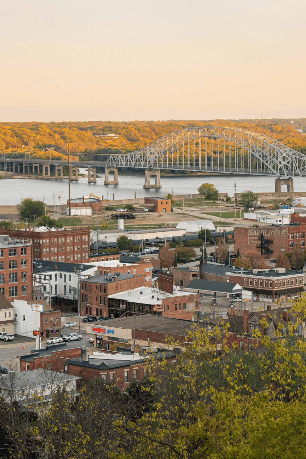 Historic downtown river city skyline with bridge, autumn trees, and urban landscape, optimized for travel and navigation keywords.
