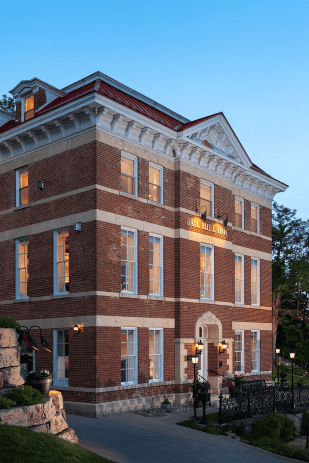 Historic brick inn with classic architecture, cozy ambiance, and welcoming outdoor lighting.
