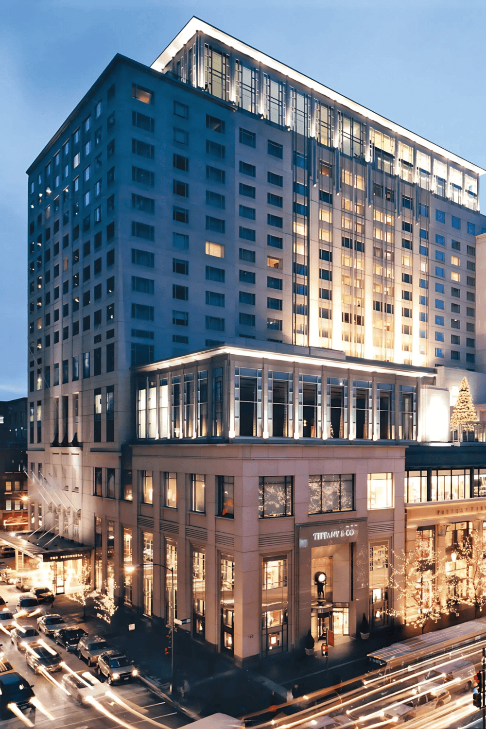 Modern luxury hotel in downtown city with Tiffany & Co. store on ground floor, vibrant nightlife, and illuminated skyscrapers.