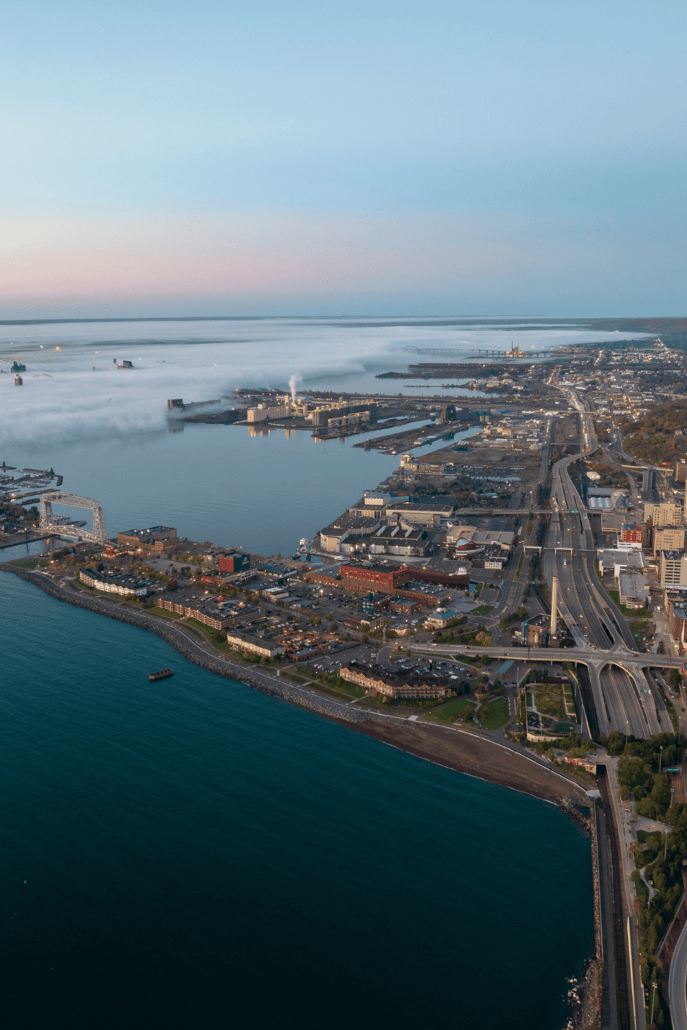 Aerial view of Tacoma, Washington, showcasing waterfront, bridges, and cityscape.