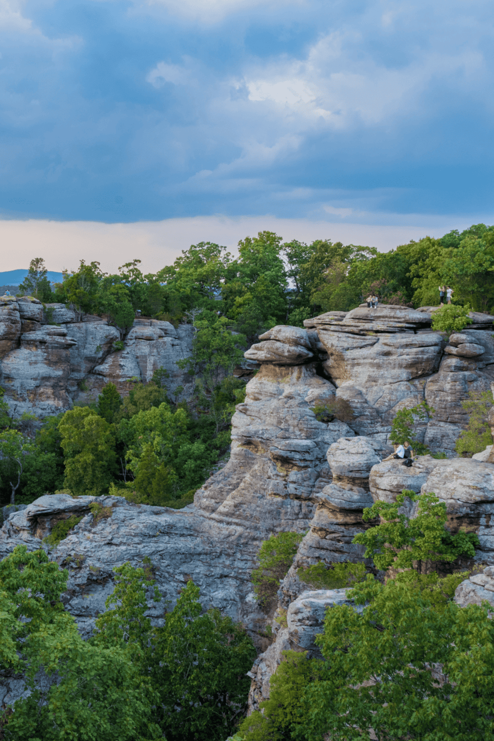 Majestic rocky canyon with lush greenery and a cloudy sky, perfect for outdoor adventures and nature exploration.