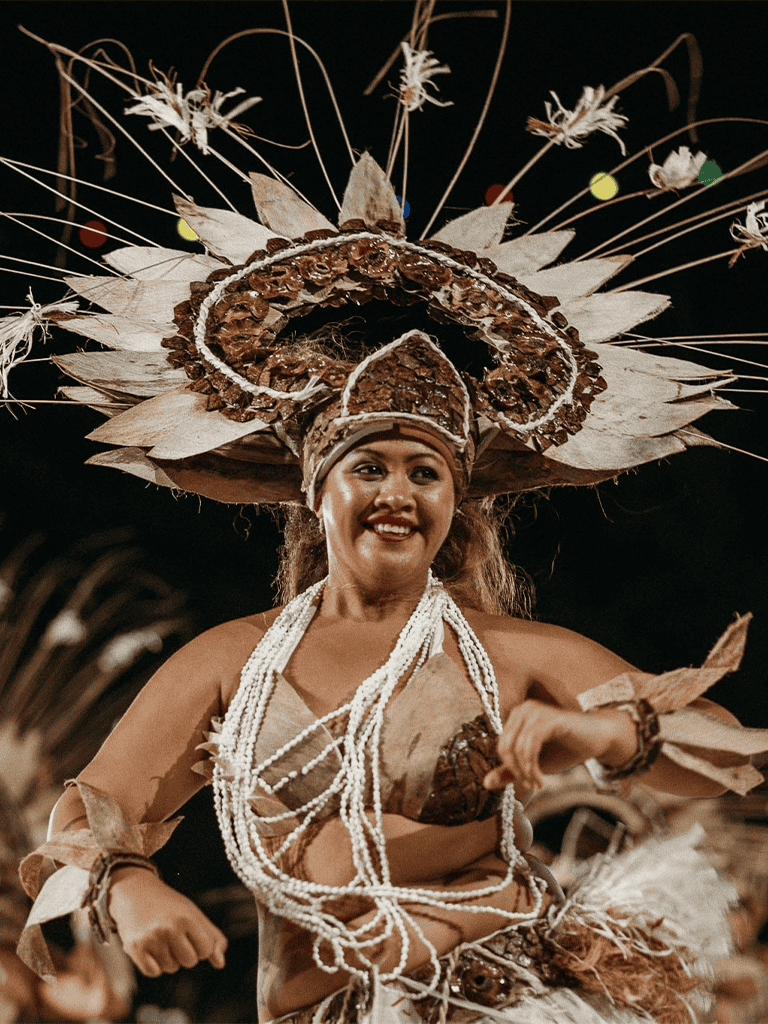 Elegant indigenous woman in traditional attire during cultural dance performance.