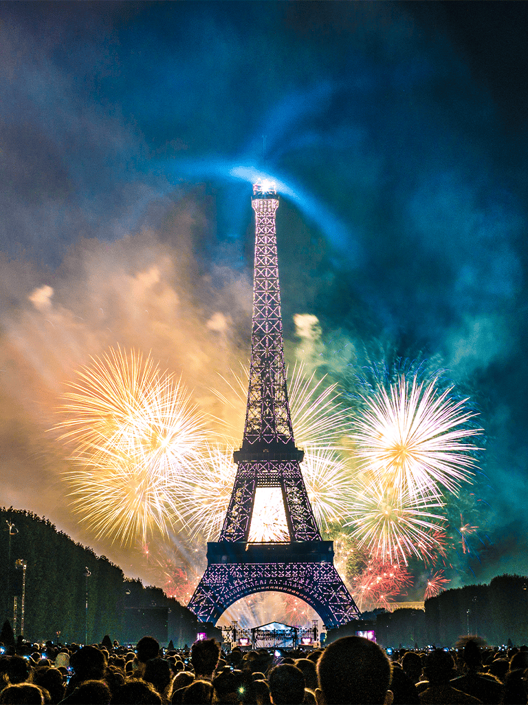 Bright fireworks illuminate the Eiffel Tower during a spectacular celebration in Paris, France.