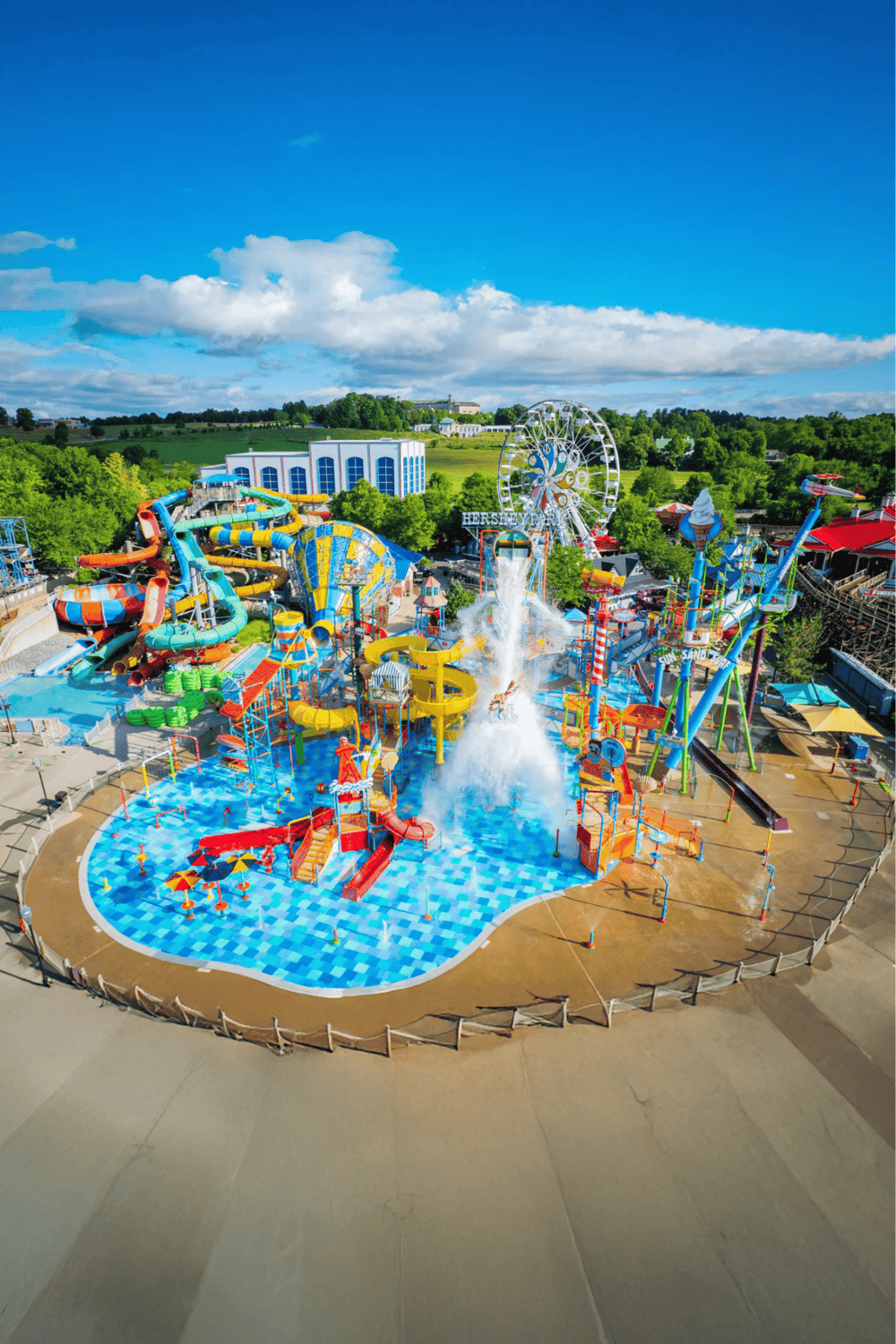 Water park with colorful slides and Ferris wheel at Hersheypark in Pennsylvania, an exciting family-friendly amusement park.