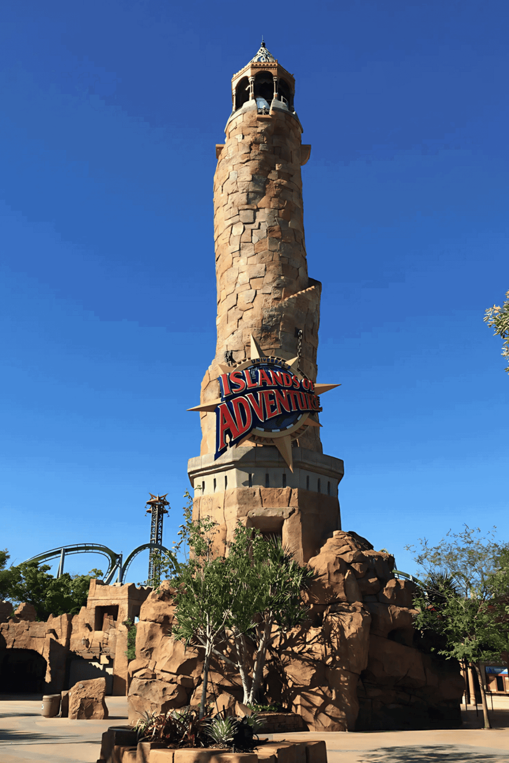 Adventure-themed tower at Islands of Adventure, Universal Studios, with clear blue sky background.