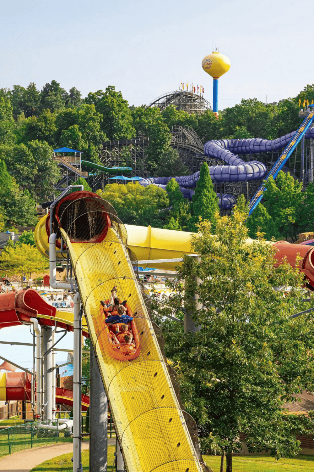 1. Water park with water slides and lush greenery, family-friendly outdoor entertainment.