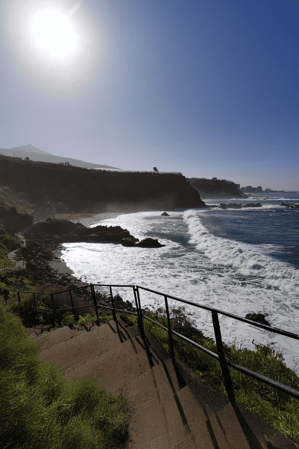 Vibrant coastal scenery with cliffs, ocean waves, and clear blue sky at QuestForDirections location.