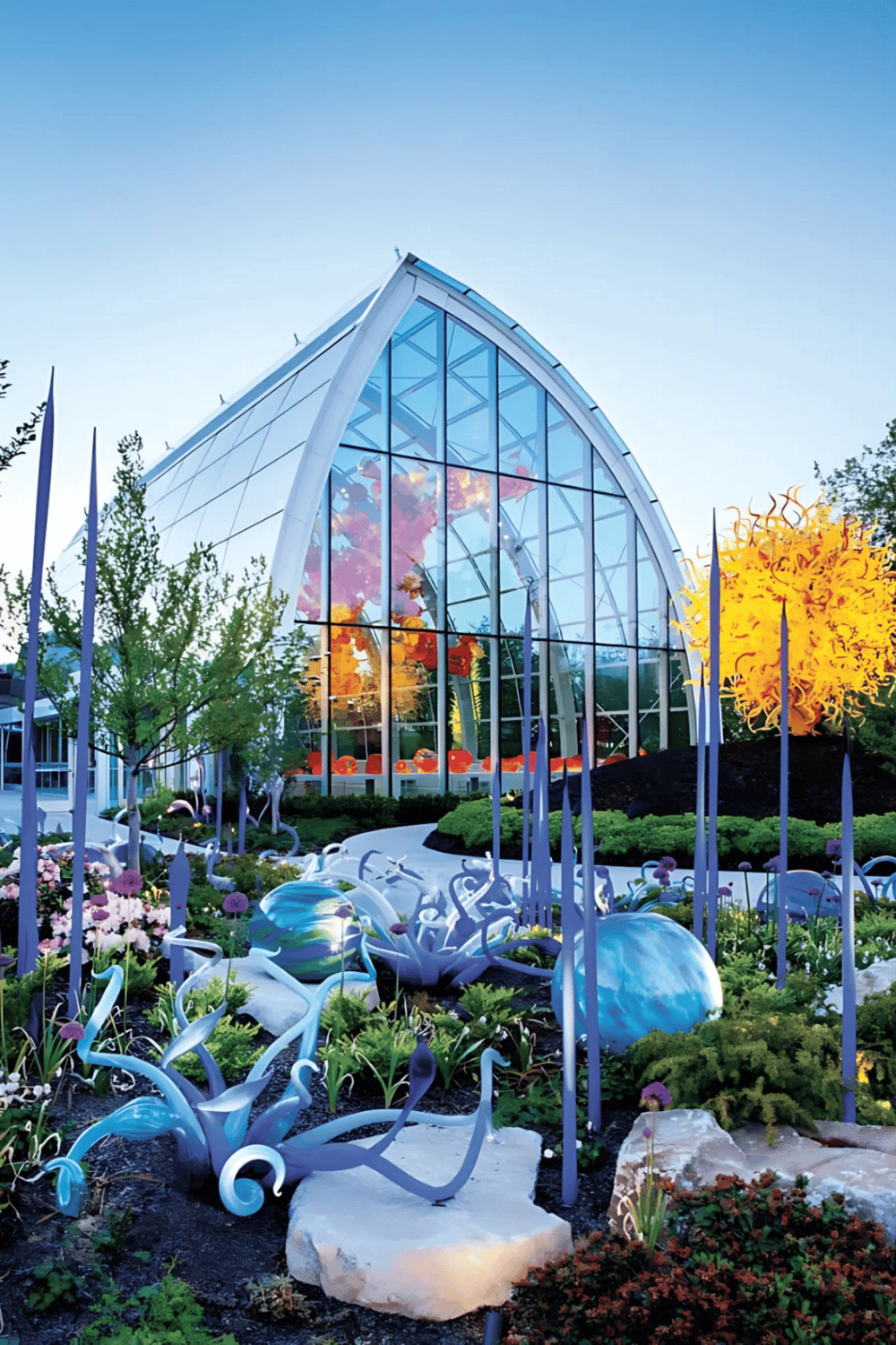 Colorful glass conservatory with floral garden at Quest for Directions.