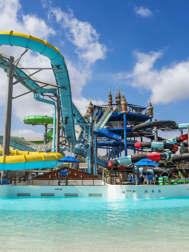 Water park with colorful slides and a castle, ideal for family fun and adventure.