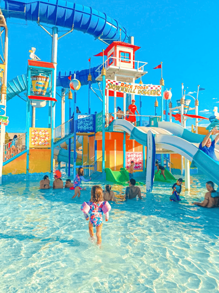 Colorful water park with slides and children enjoying the water fun.