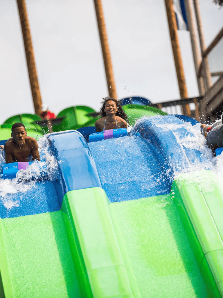 Thrilling water park rides with kids on colorful slides, fun and adventure for family entertainment.