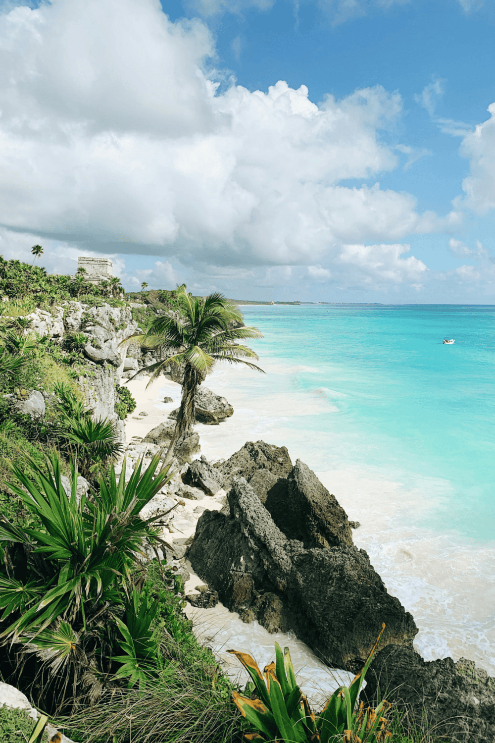 Pristine Caribbean Beach with turquoise waters, lush greenery, and ancient Mayan ruins. Perfect for travel and adventure.