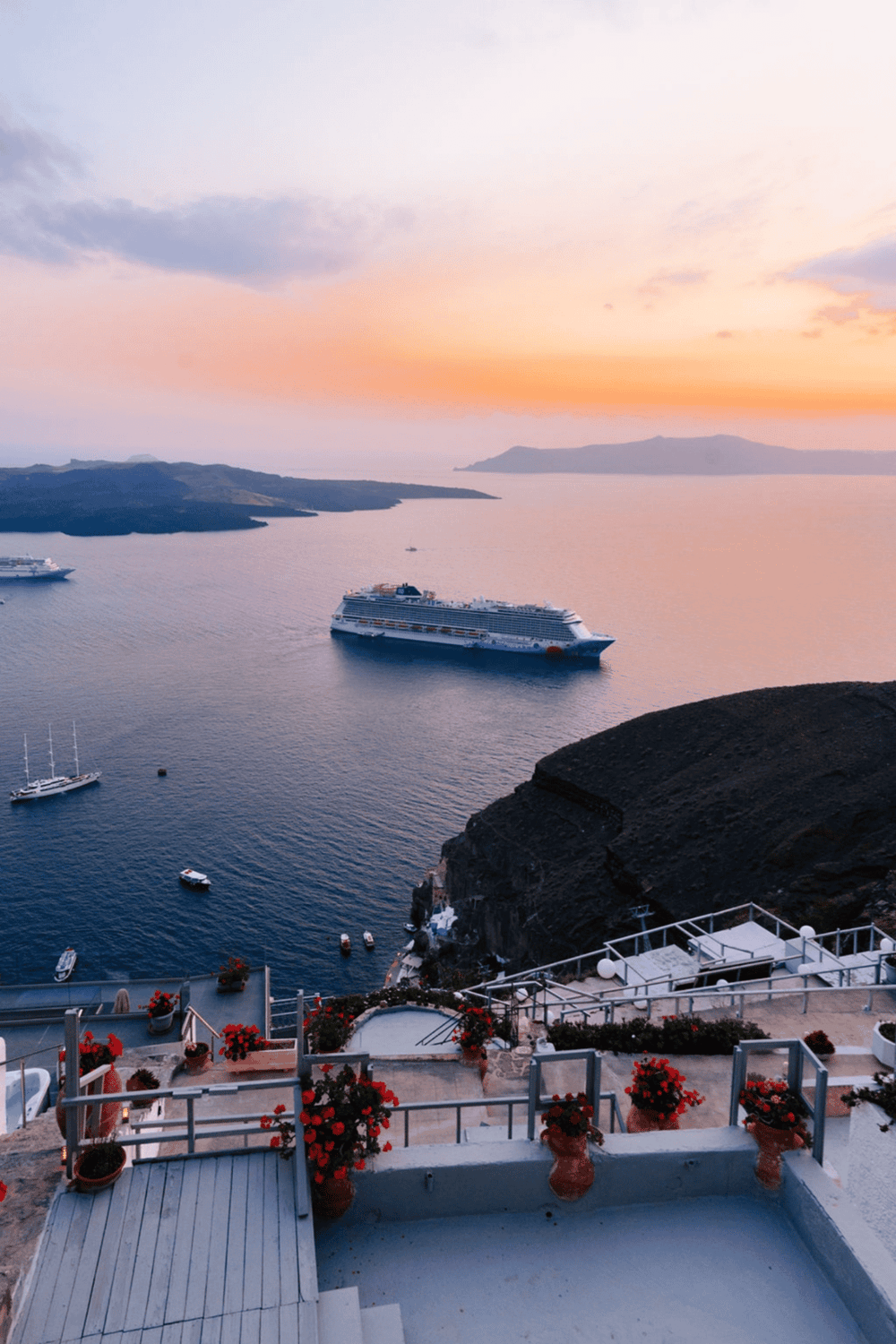Cruise ship sailing near Greek islands at sunset, scenic travel destination for vacationers.
