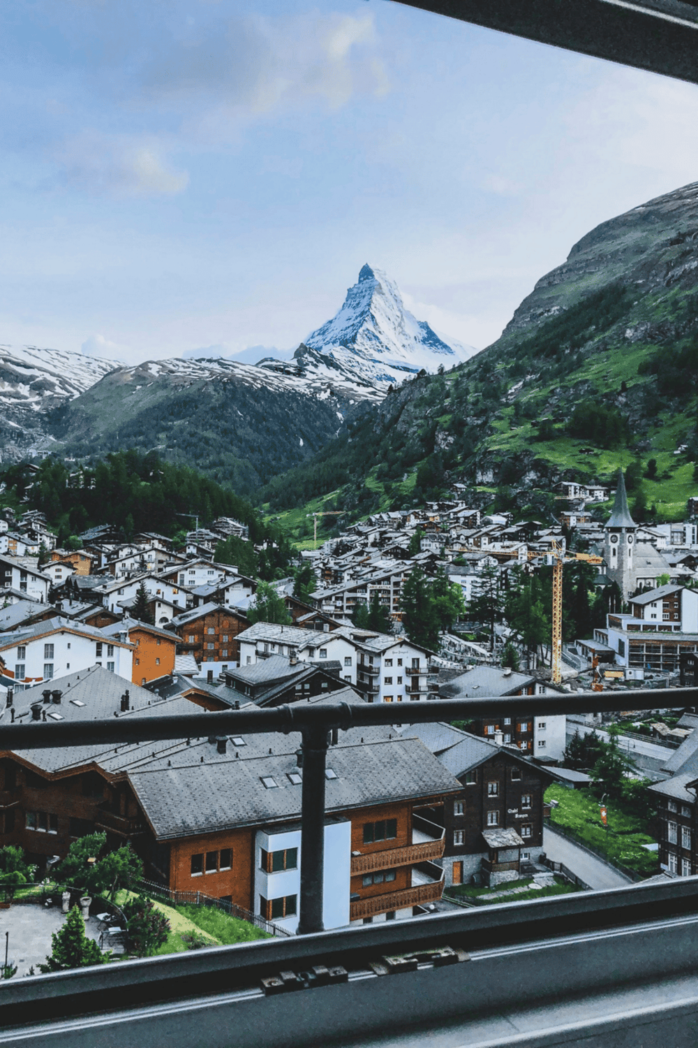 Panoramic view of Zermatt town with the iconic Matterhorn mountain in the background, perfect for mountain resort travel and adventure enthusiasts.