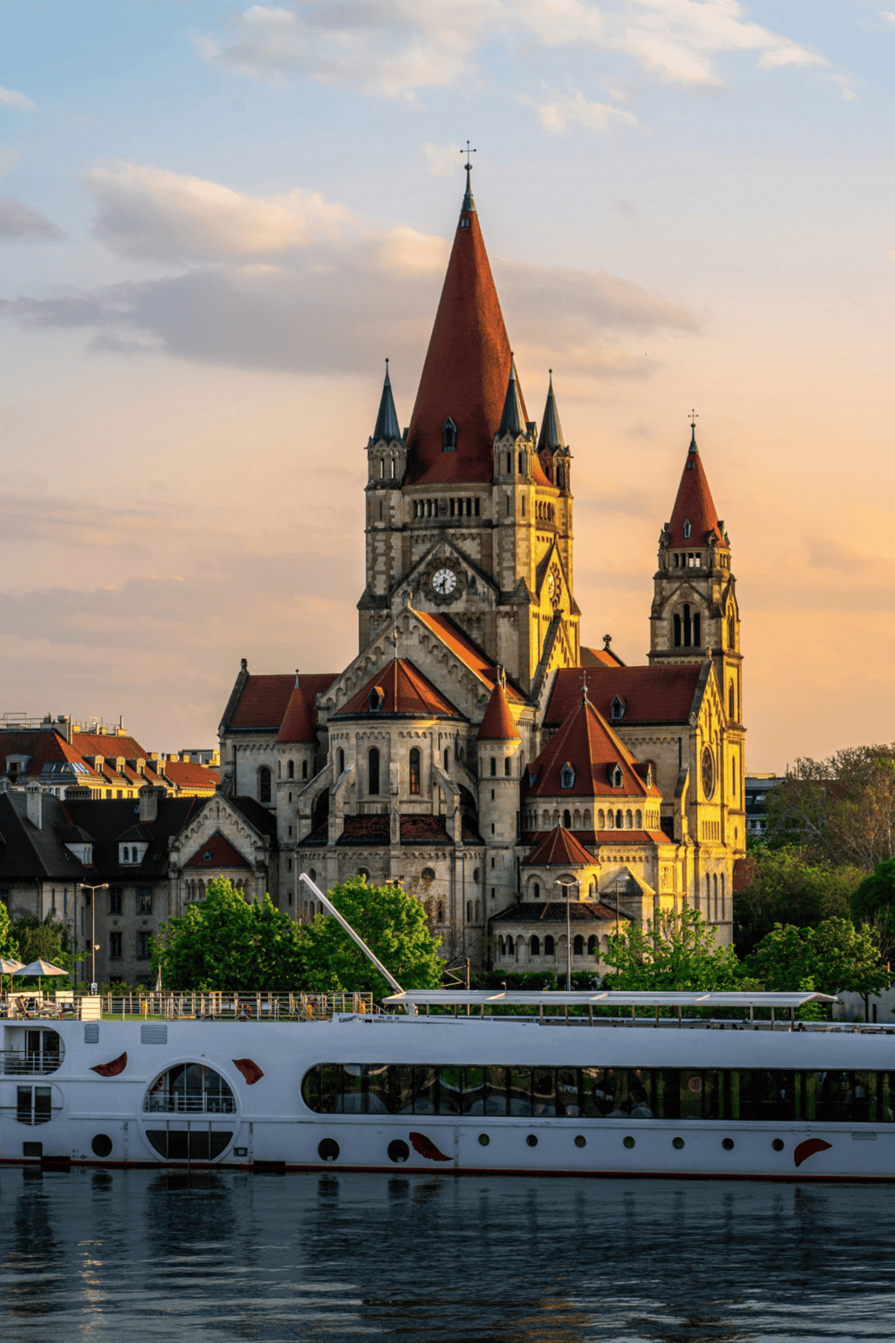1. Strasbourg Cathedral with river cruise ship at sunset, iconic tourism landmark in Strasbourg, France.