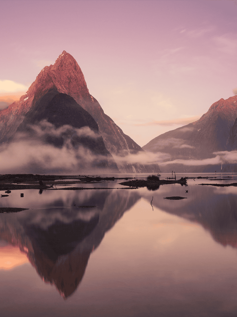 Serene mountain landscape with dramatic peaks and reflective water, perfect for adventure and travel destinations.