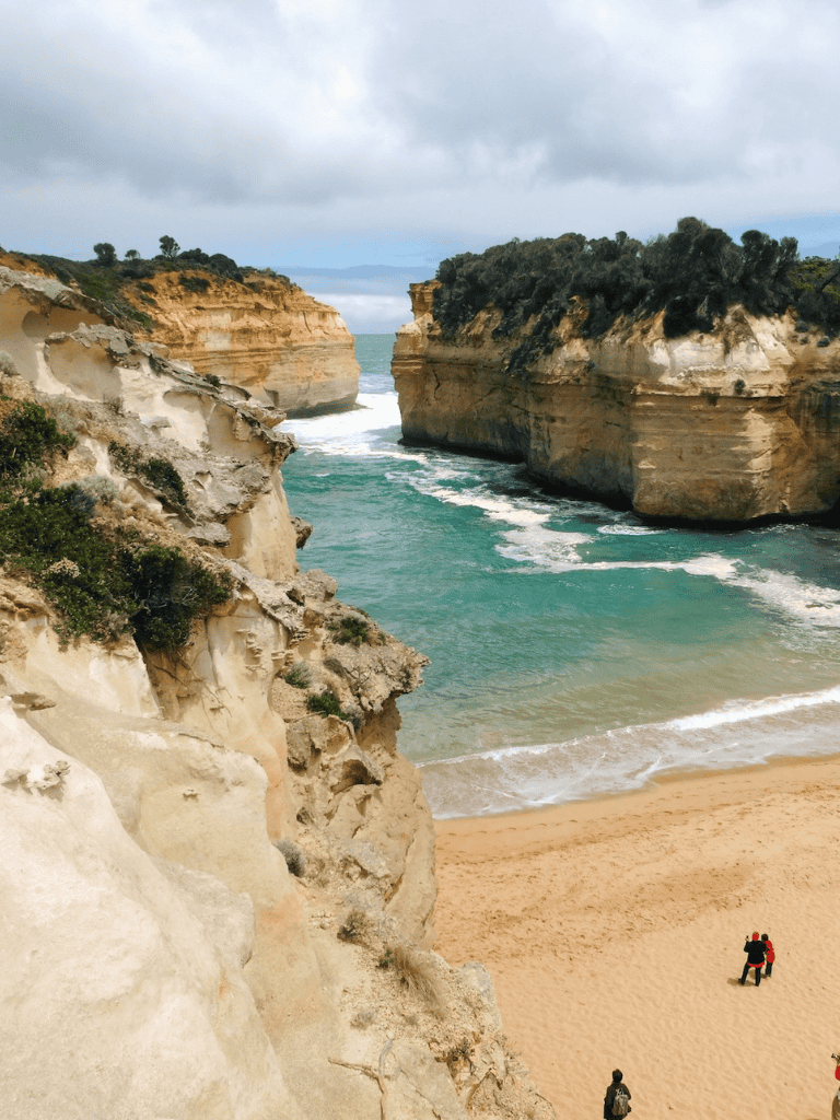 Secluded beach with dramatic cliffs, turquoise waters, and hiking adventure opportunities.