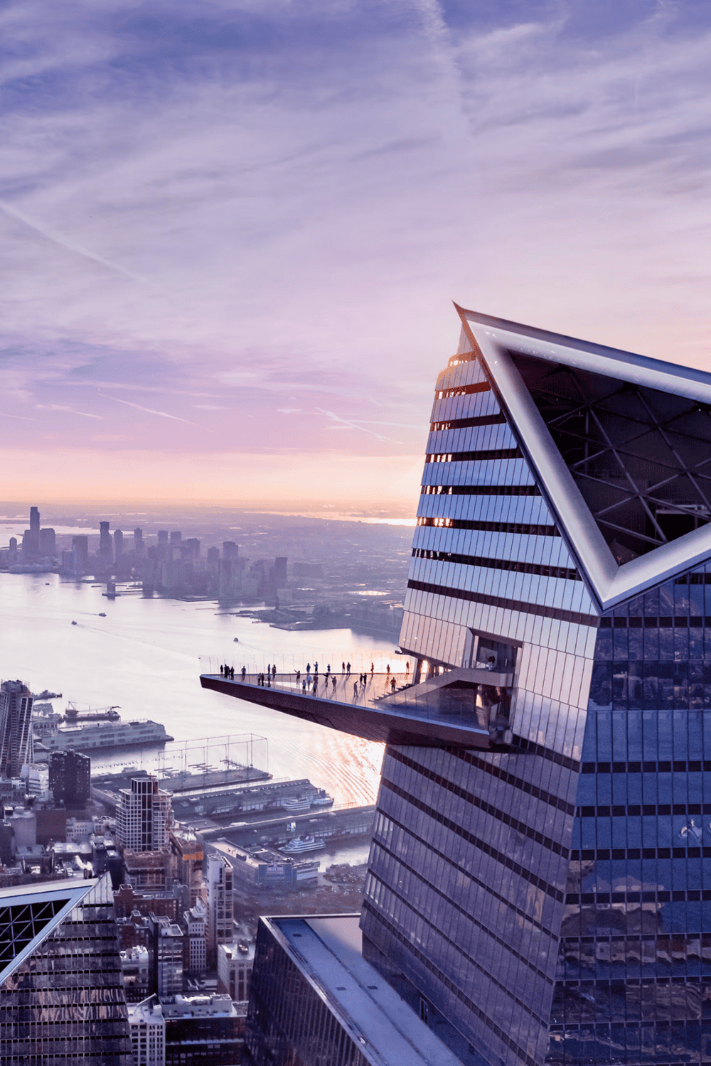 Spectacular view of a modern skyscraper with urban skyline and river at sunset, representing city exploration.