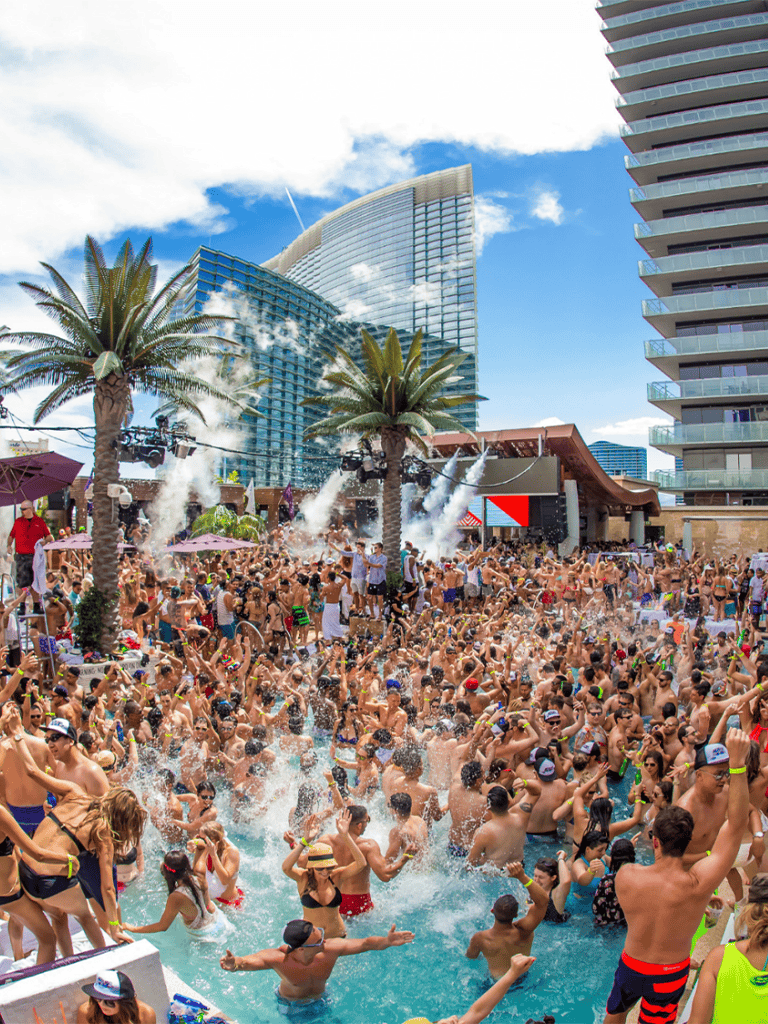 Lively pool party with a large crowd at Quest for Directions, vibrant city skyline background, perfect for travel and entertainment SEO.