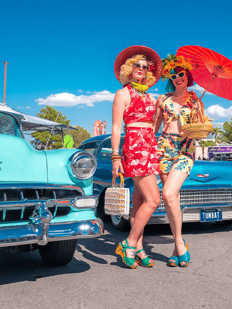 Vintage summer women retro fashion at classic car show.