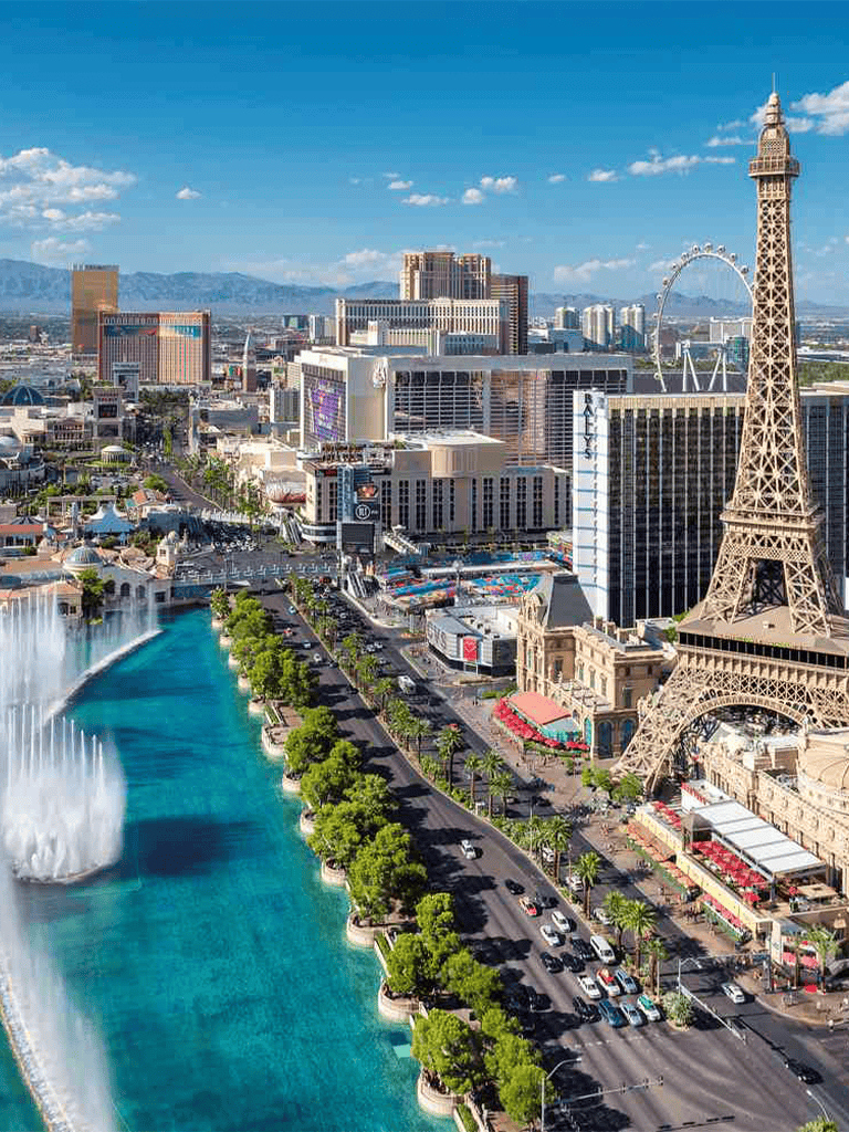 Vibrant Las Vegas Strip with Eiffel Tower replica and Fountain Show, Nevada entertainment hub.