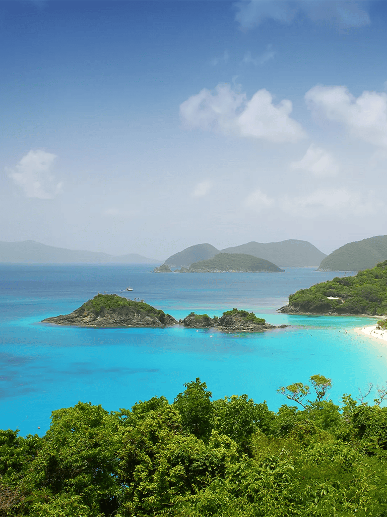 Vibrant turquoise ocean with lush green islands and a scenic coastal view.
